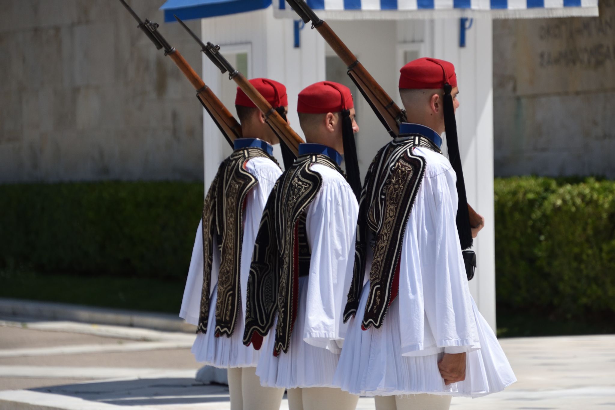 Greek national guards (Evzones) in front of the Tomb of the Unknown Soldier near building of Parliament