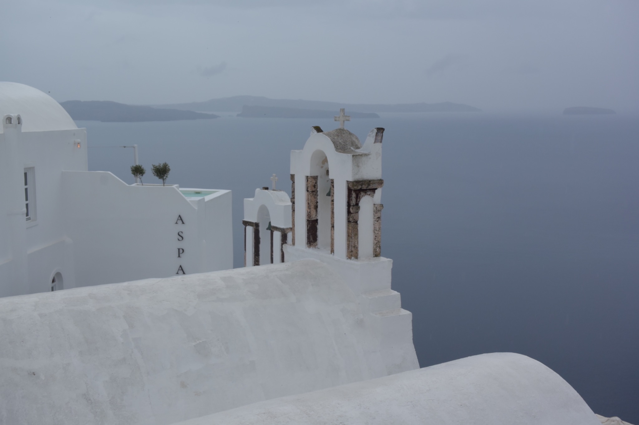 A white church with bells and a bell tower